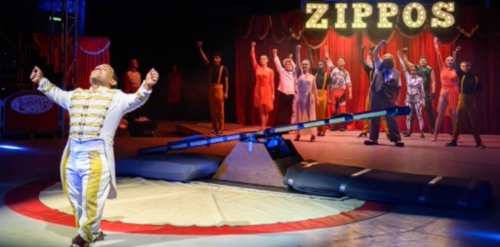 Circus ringleader gesturing to the audience.