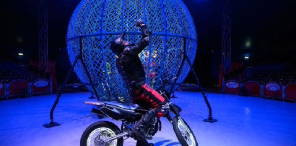 Circus performance ring with a person on a motorbike.