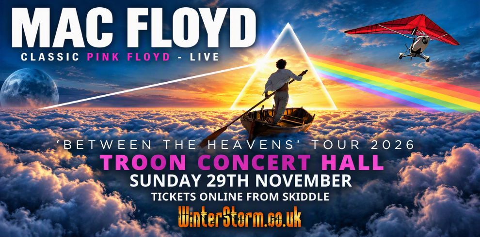 Promotional banner for Mac Floyd, a Pink Floyd tribute concert. The image shows a person standing in a small rowing boat above a sea of clouds at sunset, facing a glowing triangular prism with a rainbow beam extending across the sky. A red hang glider flies in the upper-right corner, and a moon is visible on the left. Text reads: “MAC FLOYD - Classic Pink Floyd Live”, “Between the Heavens’ Tour 2026”, “Troon Concert Hall”, “Sunday 29th November”, “Tickets Online from Skiddle”, and “winterstorm.co.uk”. The design uses vivid blue, pink, orange and rainbow colours inspired by classic Pink Floyd imagery.