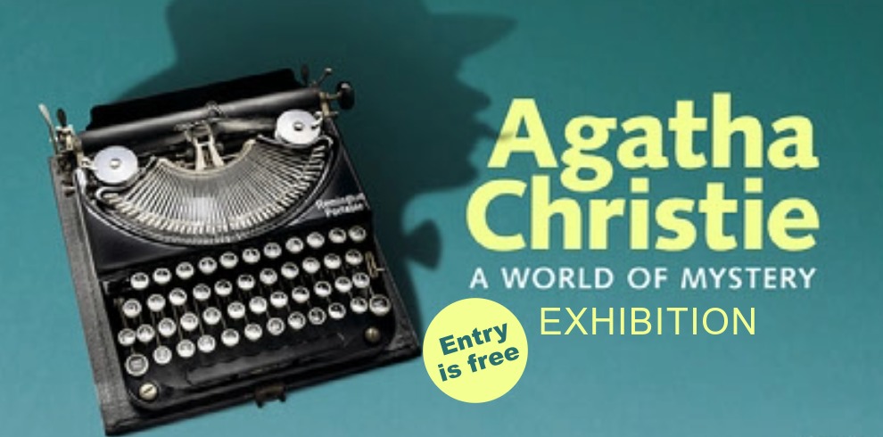 Promotional graphic for Agatha Christie: A World of Mystery exhibition. A vintage black typewriter appears on the left against a teal background, with the shadowed silhouette of a person wearing a hat in the background. Large yellow text reads “Agatha Christie” with smaller text underneath saying “A World of Mystery” and “Exhibition.” A circular badge states “Entry is free.” The Living Knowledge Network and British Library logos appear in the top-right corner, with partner logos along the bottom.