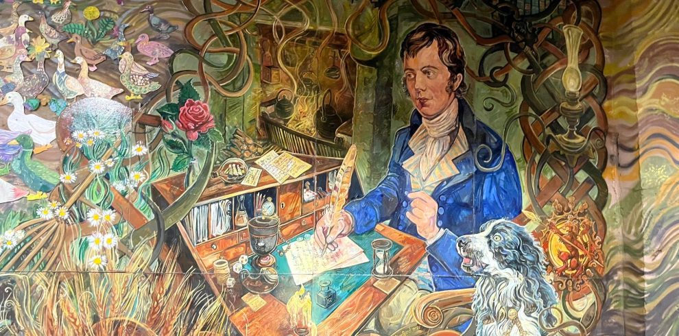 Beautiful painted mural in a tunnel, with lots of images of Robert Burns and Scotland
