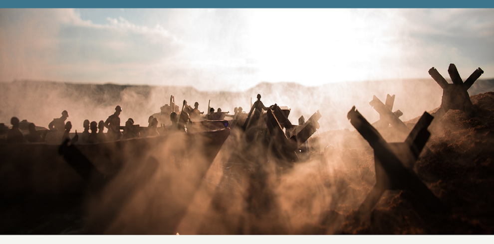 An eiry looking image of a smoked filled battlefiled showing service men in what looks like a tank.