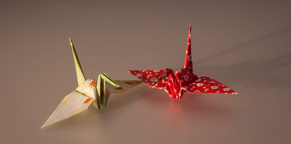 A picture of two colourful origami birds.