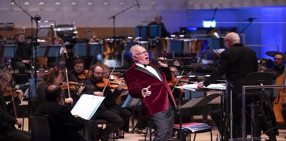 A picture of the the BBC Scottish Symphony Orchestra performing on stage.