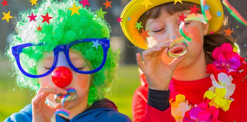 Two children dressed up as clowns.