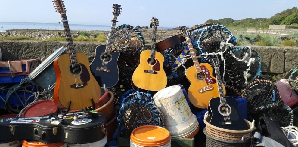 Several acoustic guitars and fishing nets.
