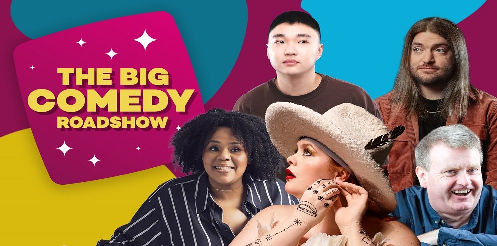 This image is a promotional poster for "The Big Comedy Roadshow." It features five comedians, each with a unique style and personality, arranged against a vibrant background. In the top left corner, a large magenta square with sparkles displays the show's title in bold, yellow letters. The comedians' expressions range from playful to curious, capturing a lighthearted and comedic atmosphere. The background is divided into bold, contrasting colors of blue, magenta, and yellow, adding energy to the poster. Each comedian stands out with distinct clothing and accessories, hinting at their individual comedic styles.