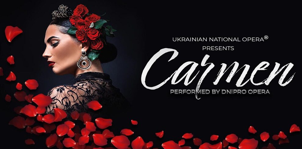 Black background with the title Carmen in white font. A lady has red roses in her hair and the petals flow over the image.